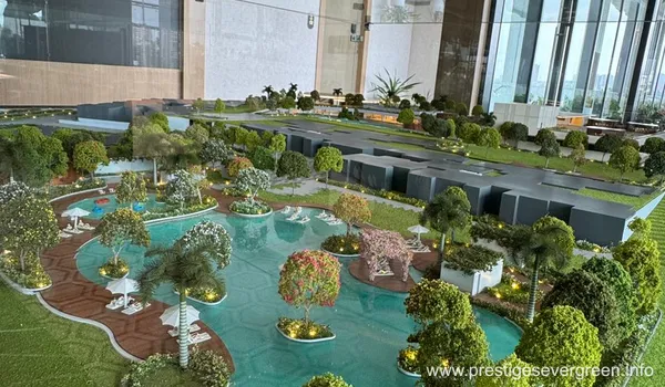 Scale model of Prestige Evergreen Whitefield showing luxury swimming pool and tropical landscaping amenities.