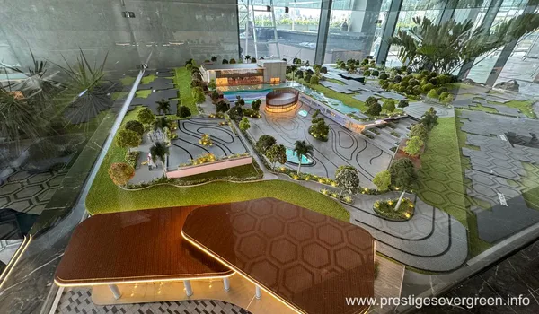 Detailed scale model of Prestige Evergreen showcasing the clubhouse, swimming pool, and lush green forest-themed landscaping.